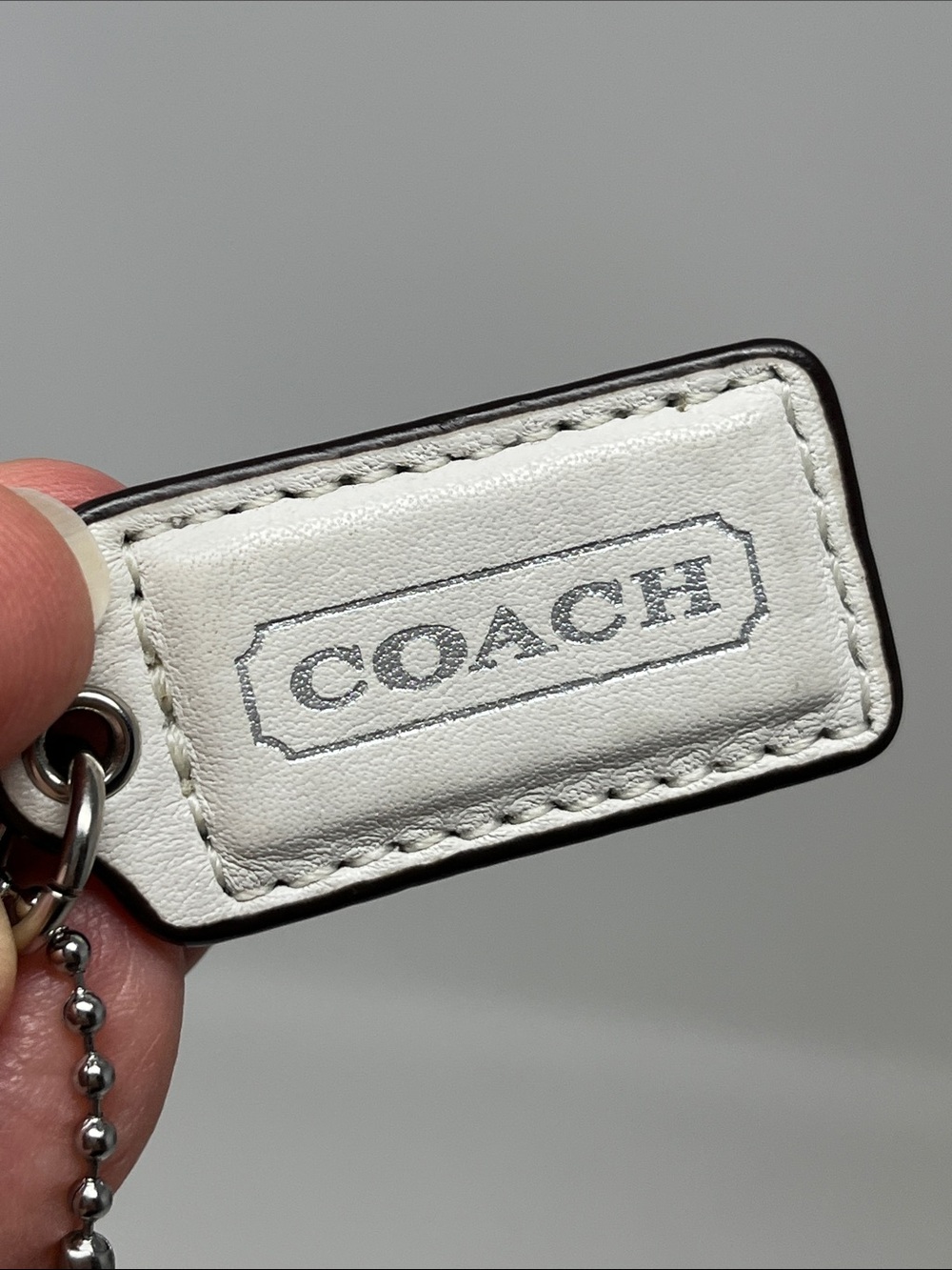 COACH HANG TAG WHITE AND SILVER WITH BONUS PINK SPARKLE MATTE SILVER KEYCHAIN - Picture 2 of 11